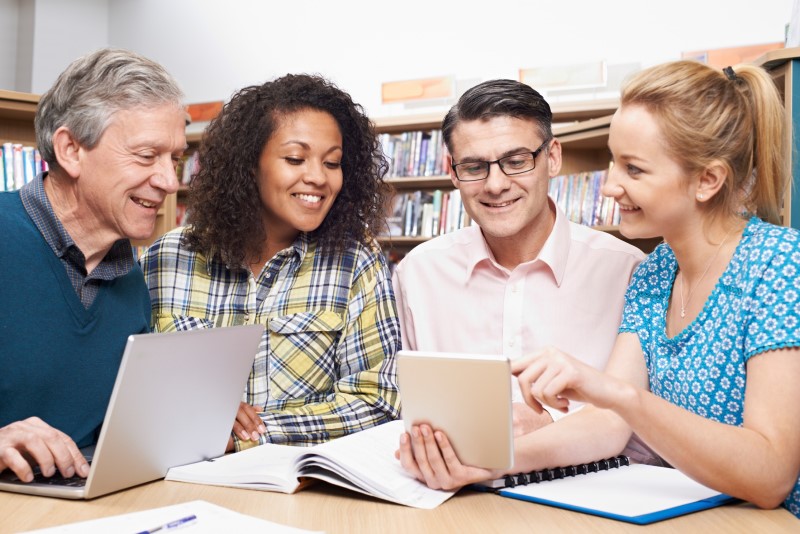 a banner image with title senior scholars. Elderly students are sitting in a classroom.