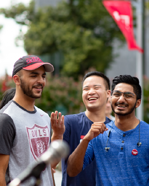 three international students chatting and laughing